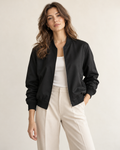 Woman wearing Solenne minimal bomber jacket in black